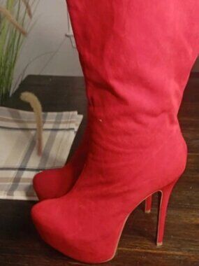 red faux-suede knee-high platform boots featuring a distinctive hidden leopard p